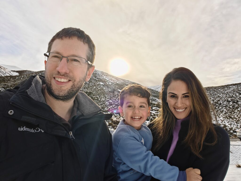 Newly arrived family standing in scenic New Zealand